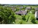 An aerial shot from the back of the home showing the backyard lawn, fence, and trees at 1431 Leitrim Loop, Apopka, FL 32703