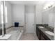 Bright bathroom with dual sinks, granite countertops, and a soaking tub at 1431 Leitrim Loop, Apopka, FL 32703