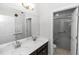 Bathroom featuring double sink vanity and large mirror and a walk-in shower with glass door at 1431 Leitrim Loop, Apopka, FL 32703
