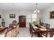 Formal dining room features a large wooden table, china cabinet, and traditional decor at 1431 Leitrim Loop, Apopka, FL 32703