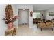 Elegant foyer with decorative mirror, tiled floor, and view into a beautifully furnished living room at 1431 Leitrim Loop, Apopka, FL 32703