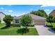 Charming single-story home with a paver driveway, attached garage, and well-manicured landscaping at 1431 Leitrim Loop, Apopka, FL 32703