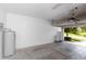 The garage showing the cinderblock wall, hot water heater, and door track system at 1431 Leitrim Loop, Apopka, FL 32703