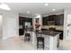Spacious kitchen with stainless steel appliances, island with seating, and dark wood cabinets at 1431 Leitrim Loop, Apopka, FL 32703