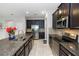 Well-equipped kitchen with stainless steel appliances, granite countertops, and dark wood cabinetry at 1431 Leitrim Loop, Apopka, FL 32703