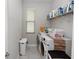 Functional laundry room equipped with a washer, dryer, and storage shelves at 1431 Leitrim Loop, Apopka, FL 32703