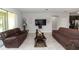 Cozy living room with matching sofas, tile flooring, and modern entertainment setup at 1431 Leitrim Loop, Apopka, FL 32703