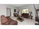Bright living room features comfortable seating, decorative accents, and sliding glass door to the porch at 1431 Leitrim Loop, Apopka, FL 32703
