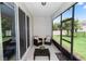 Enclosed patio includes outdoor seating and view of the backyard at 1431 Leitrim Loop, Apopka, FL 32703