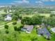 Expansive aerial view of a home and screened in pool, situated on a golf course at 1507 Golfside Dr, Winter Park, FL 32792