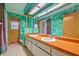 Unique bathroom with a double vanity, skylights, and colorful green walls, offering a retro vibe at 1507 Golfside Dr, Winter Park, FL 32792