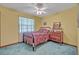Cozy bedroom with a window for natural light, adorned with a classic dresser and decorative mirror at 1507 Golfside Dr, Winter Park, FL 32792