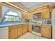 Well-lit kitchen showcasing wooden cabinets, a blue countertop, and classic appliances at 1507 Golfside Dr, Winter Park, FL 32792