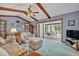 Spacious living room features a vaulted ceiling and a view of the outdoor pool area at 1507 Golfside Dr, Winter Park, FL 32792