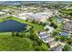 Aerial view displaying nearby shopping along with a pond and lush greenery adjacent to residential area at 15324 Black Lion Way, Winter Garden, FL 34787