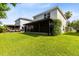 Large, green backyard with screened-in lanai and lush lawn at 15324 Black Lion Way, Winter Garden, FL 34787