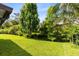 Expansive backyard featuring lush green grass and mature trees, perfect for outdoor activities at 15324 Black Lion Way, Winter Garden, FL 34787