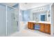 Bright bathroom with dual sinks, walk-in shower, and soaking tub at 15324 Black Lion Way, Winter Garden, FL 34787