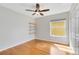 Bedroom with wood floors, shelving, and window at 15324 Black Lion Way, Winter Garden, FL 34787