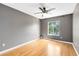 Bedroom with wood floors, window, and ceiling fan at 15324 Black Lion Way, Winter Garden, FL 34787