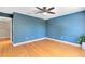 Spacious bedroom featuring hardwood floors, a ceiling fan and bright blue walls at 15324 Black Lion Way, Winter Garden, FL 34787
