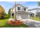 Charming two-story home with a well-maintained lawn and mature landscaping at 15324 Black Lion Way, Winter Garden, FL 34787