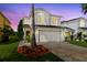 Charming two-story home with a well-maintained lawn and mature landscaping at 15324 Black Lion Way, Winter Garden, FL 34787