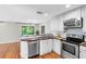Bright kitchen features white cabinets, stainless steel appliances, and wood countertops at 15324 Black Lion Way, Winter Garden, FL 34787