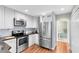 Bright kitchen features white cabinets, stainless steel appliances, and wood countertops at 15324 Black Lion Way, Winter Garden, FL 34787
