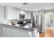 Modern kitchen featuring stainless steel appliances and white cabinetry at 15324 Black Lion Way, Winter Garden, FL 34787