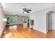 Bright living room featuring hardwood floors, ceiling fans, and natural light at 15324 Black Lion Way, Winter Garden, FL 34787
