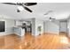 Open concept living room featuring hardwood floors and a kitchen at 15324 Black Lion Way, Winter Garden, FL 34787