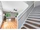 Staircase leading to the living room with hardwood floors and neutral paint at 15324 Black Lion Way, Winter Garden, FL 34787