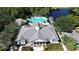 Aerial view of community clubhouse with pool, covered patios, and manicured landscaping at 15483 Avenue Of The Arbors, Winter Garden, FL 34787