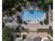 Aerial view of a community pool with ample seating and manicured landscaping at 15483 Avenue Of The Arbors, Winter Garden, FL 34787