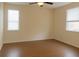 Inviting bedroom with natural light from two windows and ceiling fan at 15483 Avenue Of The Arbors, Winter Garden, FL 34787