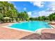 Large community pool with sun loungers and shaded pergola seating at 15483 Avenue Of The Arbors, Winter Garden, FL 34787