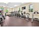 On-site fitness center featuring modern cardio machines and free weights with natural light at 15483 Avenue Of The Arbors, Winter Garden, FL 34787