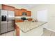 Kitchen features stainless steel appliances, granite counters, and breakfast bar seating at 15483 Avenue Of The Arbors, Winter Garden, FL 34787
