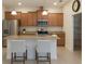 Modern kitchen with stainless steel appliances, granite countertops, and a breakfast bar at 15483 Avenue Of The Arbors, Winter Garden, FL 34787