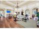 Elegant lounge area with comfortable seating, hardwood floors, and stylish decor at 15483 Avenue Of The Arbors, Winter Garden, FL 34787