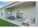 Covered patio featuring a cozy seating area and neutral finishes, perfect for relaxation and entertaining at 1802 Lattice Way, St Cloud, FL 34771