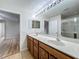 Bathroom featuring a double sink vanity, a large mirror, and a walk-in shower at 2005 Compass Flower Way, Ocoee, FL 34761