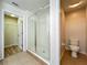 Bright bathroom featuring a tiled walk-in shower and adjacent walk-in closet at 2005 Compass Flower Way, Ocoee, FL 34761