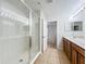 Well-lit bathroom featuring a glass enclosed shower with a view to the double sink vanity at 2005 Compass Flower Way, Ocoee, FL 34761