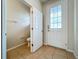 Half bathroom featuring a toilet, tiled floor, and access to a side door at 2005 Compass Flower Way, Ocoee, FL 34761