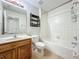 Functional bathroom features a shower-tub combination and a wood vanity with a sink at 2005 Compass Flower Way, Ocoee, FL 34761