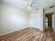 Bedroom with laminate wood floors, a ceiling fan and a closet with white doors at 2005 Compass Flower Way, Ocoee, FL 34761