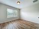 Well-lit bedroom featuring wood floors, neutral walls, and a window at 2005 Compass Flower Way, Ocoee, FL 34761