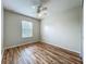 A bedroom with hardwood floors, ceiling fan and natural light from the window at 2005 Compass Flower Way, Ocoee, FL 34761